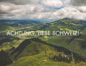 Green hills and clouds with text overlay "ACHTUNG, LIEBE SCHWEIZ!"