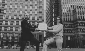 Aniek Moonen, Chair of the Dutch Youth Climate Movement, handing empty briefcase with Natural Capital to the Minister of New Economy Michel Scholte