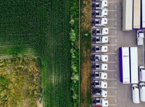 aerial view of crop field and trucks for food transport