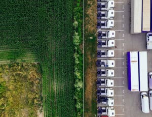 aerial view of crop field and trucks for food transport